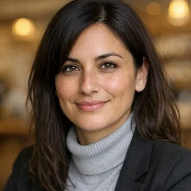 Woman in her late 30s, dark brown hair, hazel eyes, light olive skin, calm expression